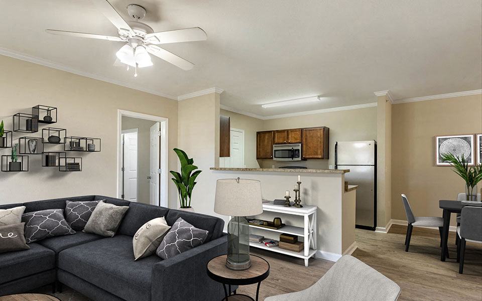 a living room with a couch and a kitchen